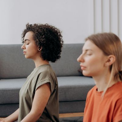 Calm person sitting with eyes closed, focusing on breath.