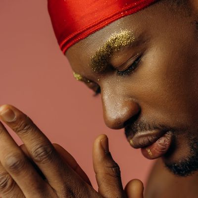 Person balancing on one leg in a bright, open space.